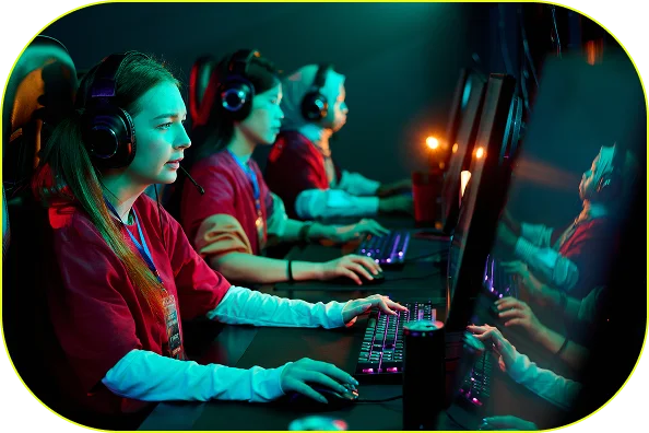 A coterie of concentrated female gamers are competing in an esports tournament while equipped with headsets. Their faces are lit brightly by glowing screens.